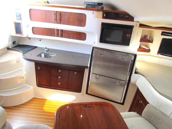  Yacht Photos Pics 2008 Grady-White Express 360 interior with kitchenette, wood cabinets, and stainless steel appliances.