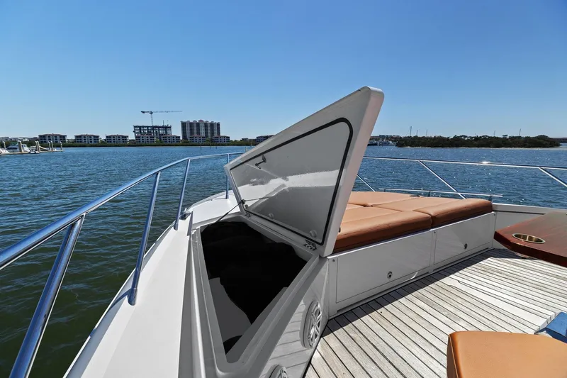 Rock Water Yacht Photos Pics 2013 Cheoy Lee 76 Alpha yacht with open hatch and sunbathing deck on calm water.