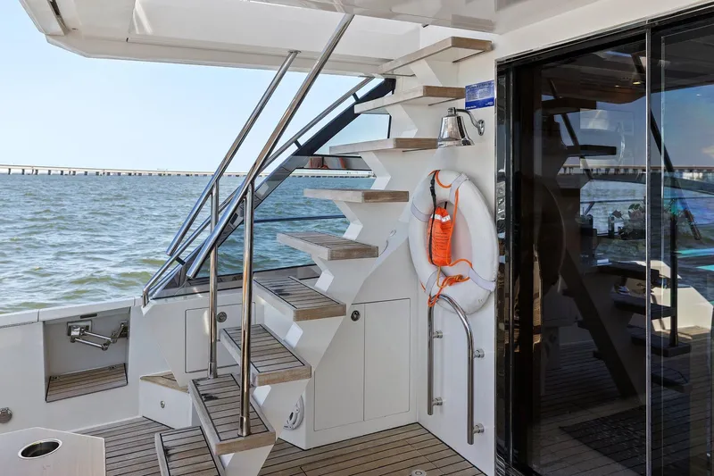 Rock Water Yacht Photos Pics Staircase on 2013 Cheoy Lee 76 Alpha yacht, overlooking serene ocean view.
