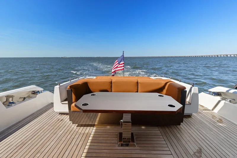 Rock Water Yacht Photos Pics Cheoy Lee 76 Alpha yacht deck with seating, table, and American flag, 2013 model.