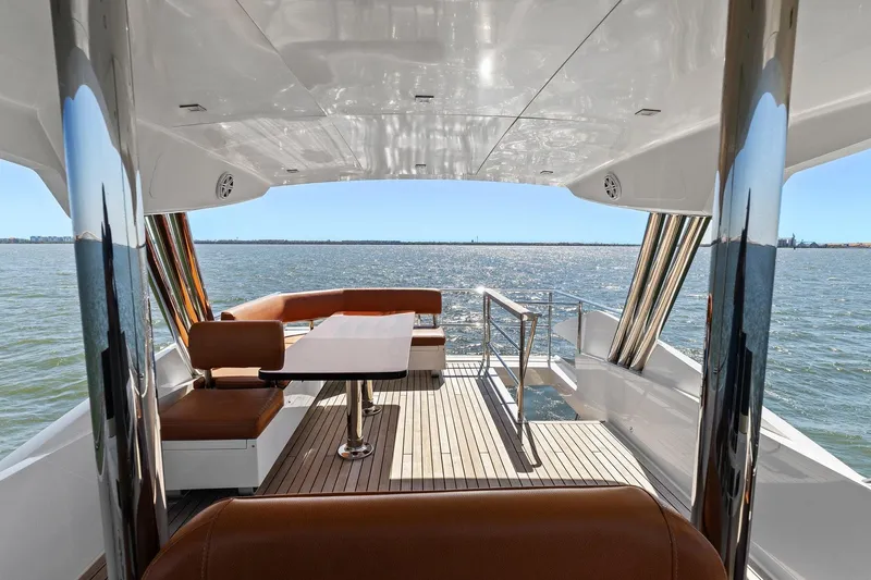 Rock Water Yacht Photos Pics Luxurious 2013 Cheoy Lee 76 Alpha yacht deck with seating, overlooking serene ocean view.