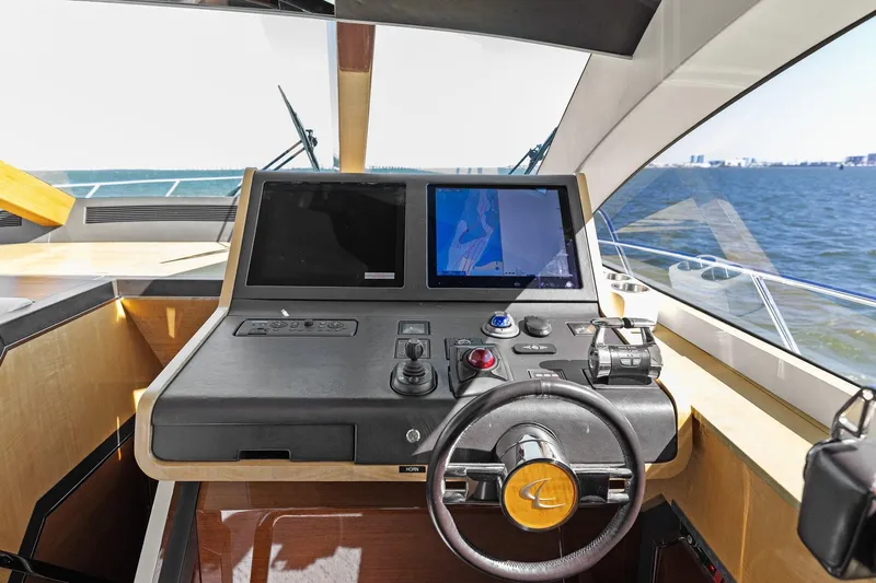 Rock Water Yacht Photos Pics 2013 Cheoy Lee 76 Alpha yacht helm with dual screens and steering wheel, overlooking the ocean.