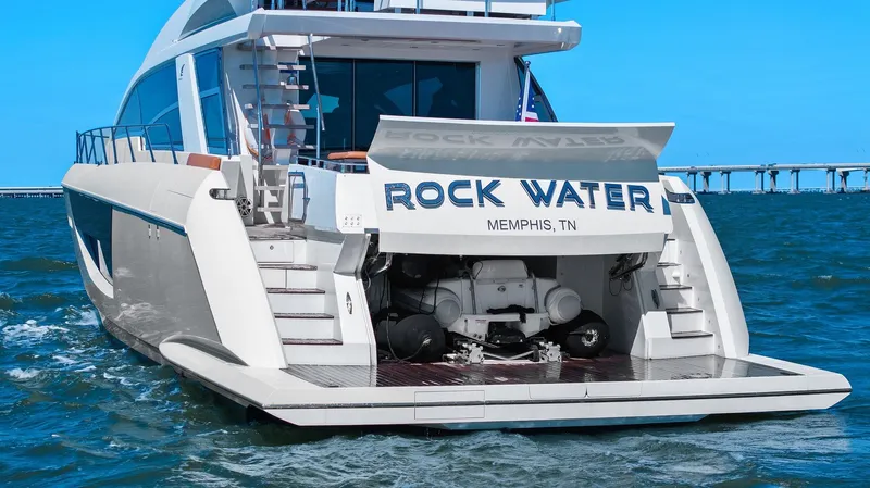 Rock Water Yacht Photos Pics 2013 Cheoy Lee 76 Alpha yacht on water, rear view with open garage.