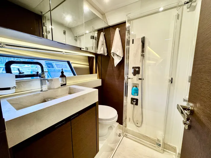 Seacresea Yacht Photos Pics Luxurious bathroom in 2019 Prestige 520 yacht with modern fixtures and glass shower.