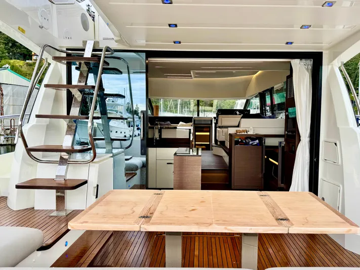 Seacresea Yacht Photos Pics Luxurious 2019 Prestige 520 yacht interior with wooden table and modern staircase.