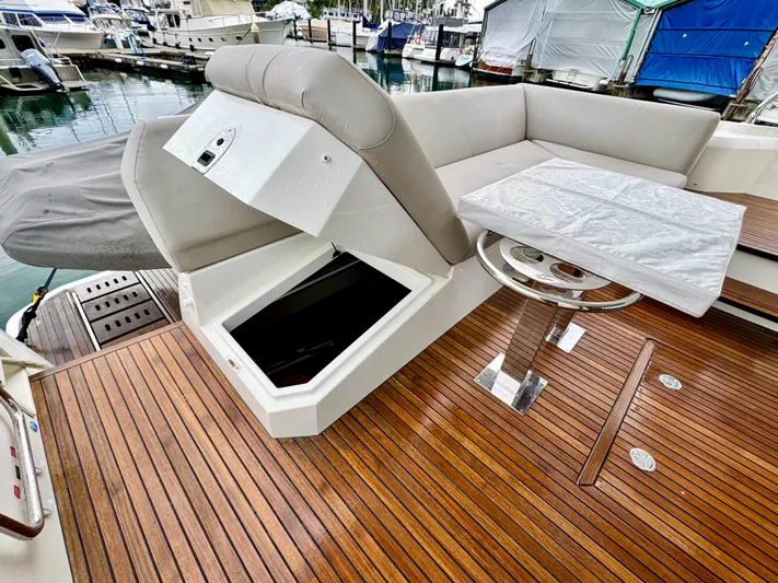 Seacresea Yacht Photos Pics Luxurious 2019 Prestige 520 yacht deck with seating, storage, and table at marina.