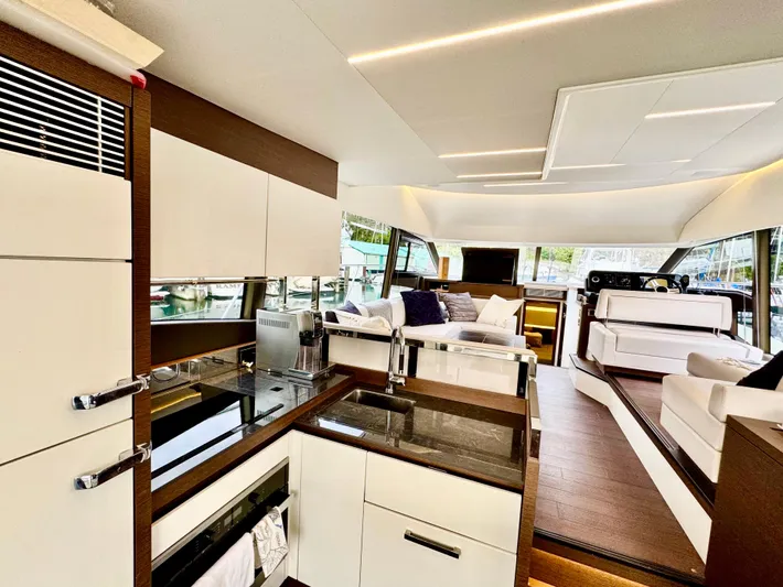 Seacresea Yacht Photos Pics Luxurious interior of a 2019 Prestige 520 yacht with modern kitchen and seating area.