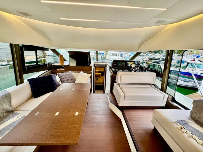 Seacresea Yacht Photos Pics Luxurious interior of a 2019 Prestige 520 yacht with elegant seating and helm station.