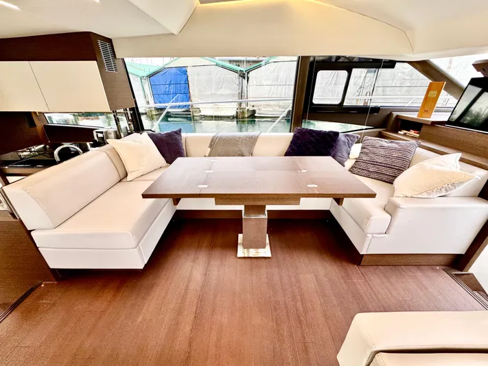 Seacresea Yacht Photos Pics Luxurious interior of 2019 Prestige 520 yacht with elegant seating and wooden table.
