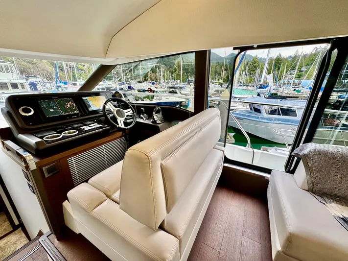 Seacresea Yacht Photos Pics Luxurious interior of 2019 Prestige 520 yacht with marina view through large windows.