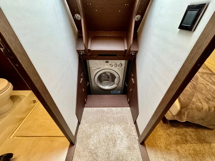 Seacresea Yacht Photos Pics Laundry area with washing machine in 2019 Prestige 520 yacht interior.