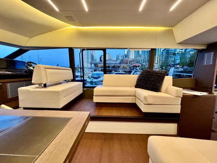 Seacresea Yacht Photos Pics Luxurious interior of a 2019 Prestige 520 yacht with modern seating and cityscape view.