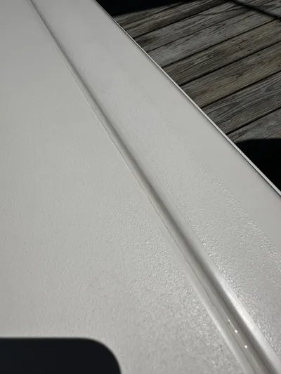 Katy Lady Yacht Photos Pics Close-up of 2017 Grady-White Canyon 376 boat surface near wooden dock.