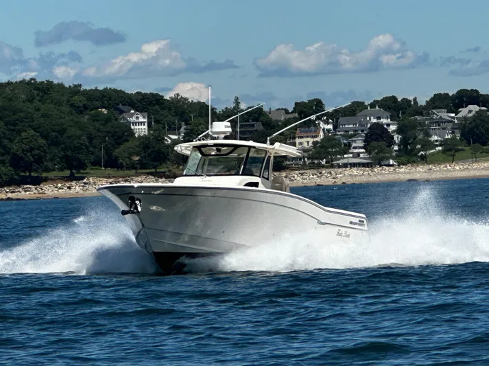 Katy Lady Yacht Photos Pics 2017 Grady-White Canyon 376 boat cruising on water near a scenic shoreline.