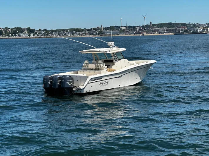 Katy Lady Yacht Photos Pics 2017 Grady-White Canyon 376 boat on water with coastal town in background.