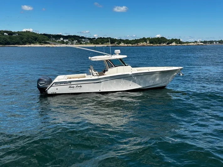 Katy Lady Yacht Photos Pics 2017 Grady-White Canyon 376 boat on calm water, clear sky background.