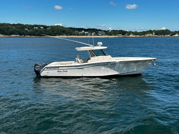 Katy Lady Yacht Photos Pics 2017 Grady-White Canyon 376 boat on calm water, clear sky, scenic background.