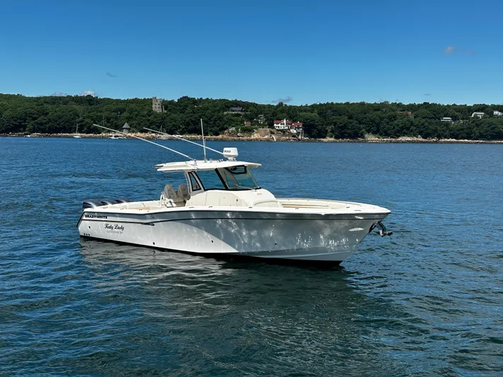 Katy Lady Yacht Photos Pics 2017 Grady-White Canyon 376 boat on calm water with scenic shoreline background.