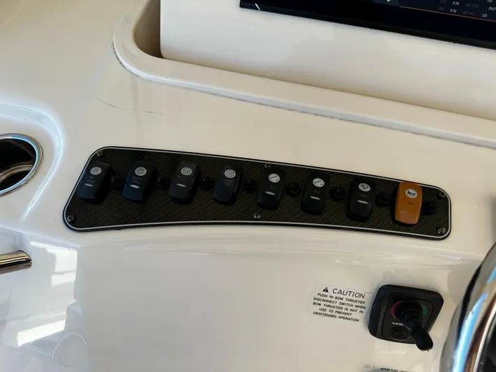Katy Lady Yacht Photos Pics Control panel of a 2017 Grady-White Canyon 376 boat with various switches and caution label.