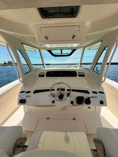 Katy Lady Yacht Photos Pics 2017 Grady-White Canyon 376 boat helm with steering wheel and controls, overlooking water.