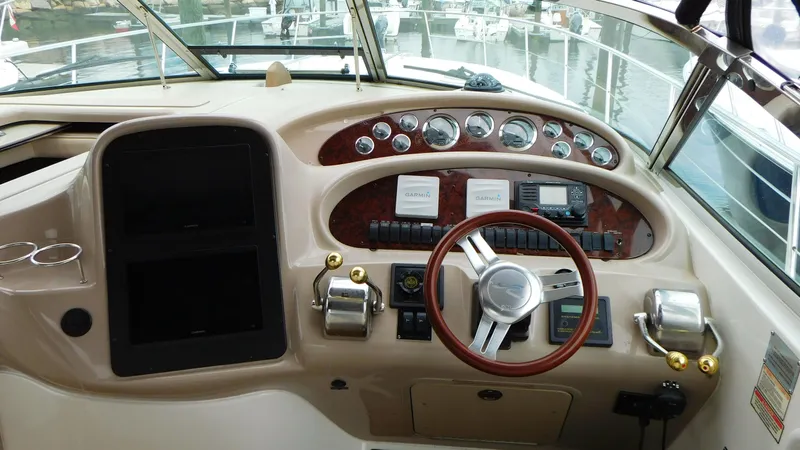  Yacht Photos Pics Helm of 2002 Sea Ray 380 Sundancer with gauges and controls, docked at marina.