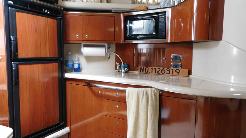  Yacht Photos Pics Interior of 2002 Sea Ray 380 Sundancer yacht kitchen with wood cabinetry and appliances.