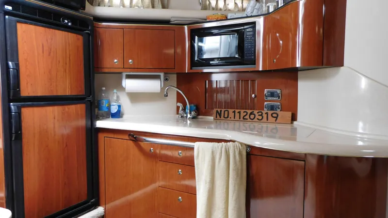  Yacht Photos Pics 2002 Sea Ray 380 Sundancer yacht kitchen with wood cabinetry and modern appliances.