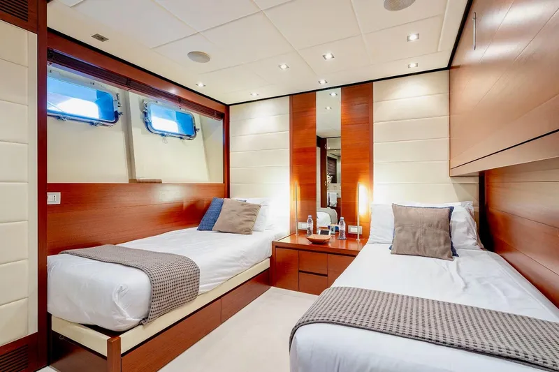  Yacht Photos Pics Luxurious twin cabin on 2007 Baglietto 43 yacht, featuring elegant wood paneling and modern decor.