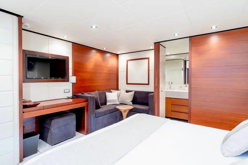  Yacht Photos Pics Luxurious interior of 2007 Baglietto 43 yacht with modern wood paneling and cozy seating area.