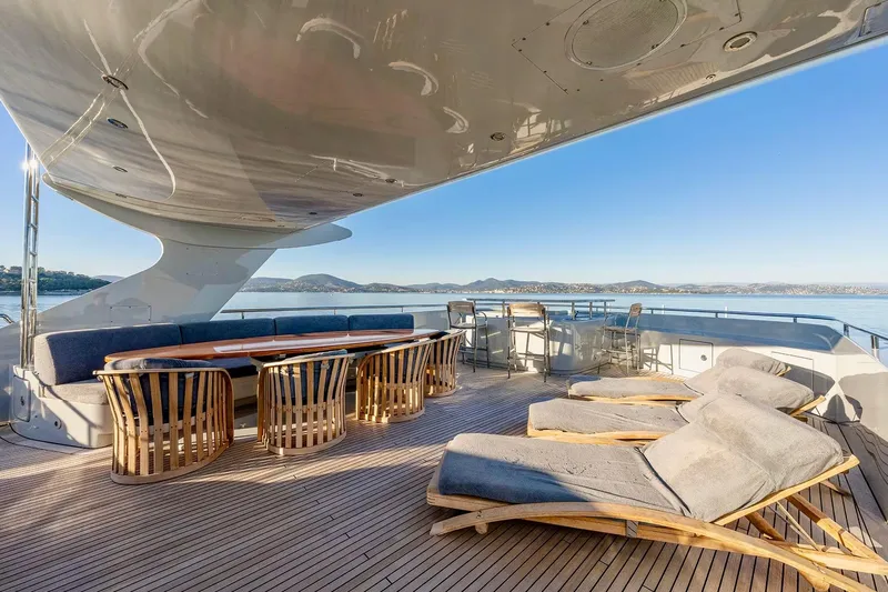  Yacht Photos Pics Luxurious 2007 Baglietto 43 yacht deck with seating and sun loungers, overlooking serene waters.