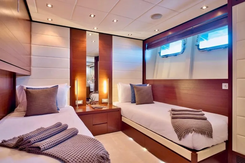  Yacht Photos Pics Luxurious twin cabin interior on 2007 Baglietto 43 yacht, featuring elegant wood and soft lighting.