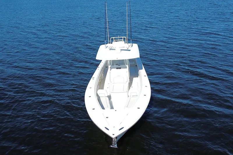 Huddle Up Yacht Photos Pics 2018 Jupiter 38 FS boat on calm blue water, aerial view.
