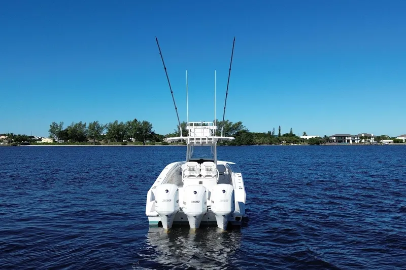 Huddle Up Yacht Photos Pics 2018 Jupiter 38 FS boat with triple engines on a calm blue lake.