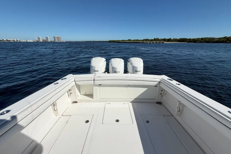 Huddle Up Yacht Photos Pics 2018 Jupiter 38 FS boat with triple engines on open water, clear sky.