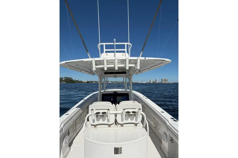 Huddle Up Yacht Photos Pics 2018 Jupiter 38 FS boat on calm water with clear blue sky.
