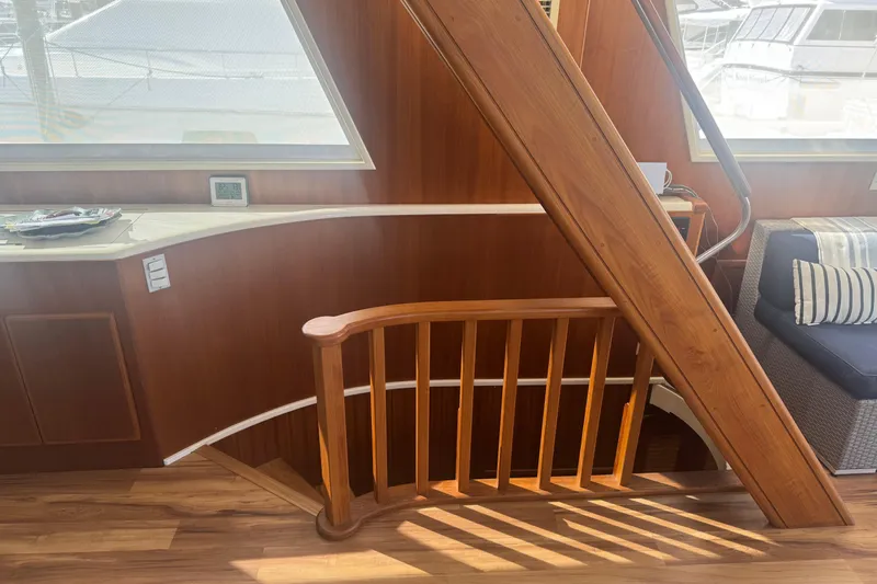Cleodora Yacht Photos Pics Interior of 1988 Viking 63 Cockpit Motor Yacht with wooden staircase and seating area.