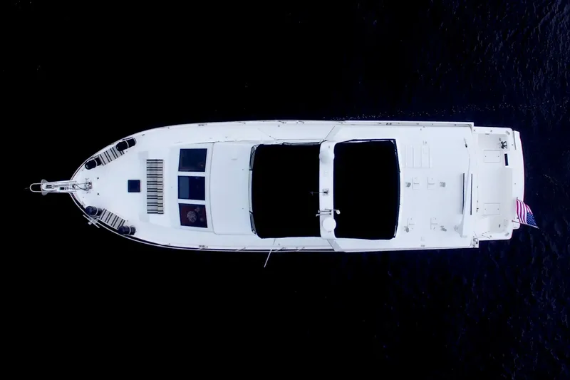 Cleodora Yacht Photos Pics Aerial view of 1988 Viking 63 Cockpit Motor Yacht on dark water.