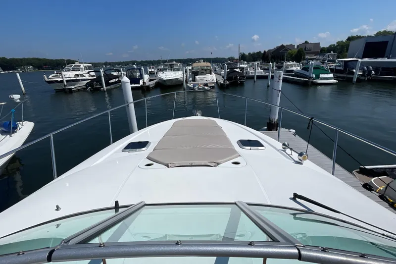  Yacht Photos Pics 2017 Rinker EX 370 yacht docked at a marina, surrounded by other boats.