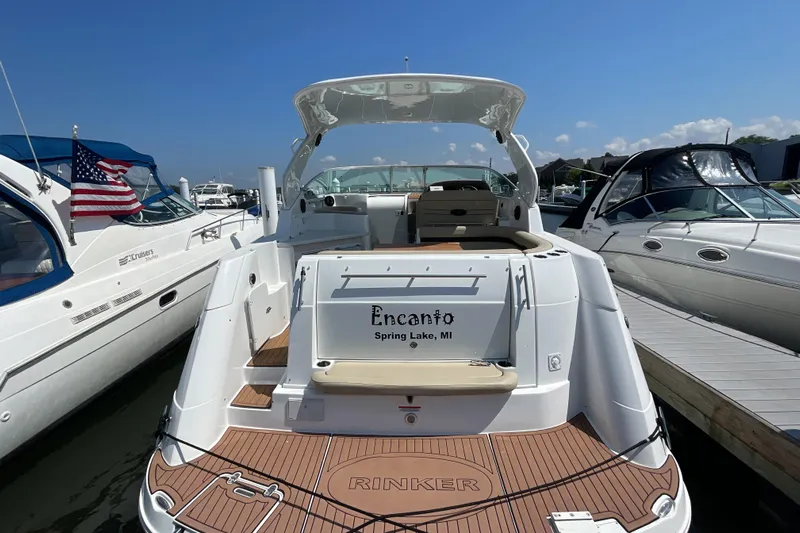  Yacht Photos Pics 2017 Rinker EX 370 boat docked, featuring a spacious deck and elegant design.