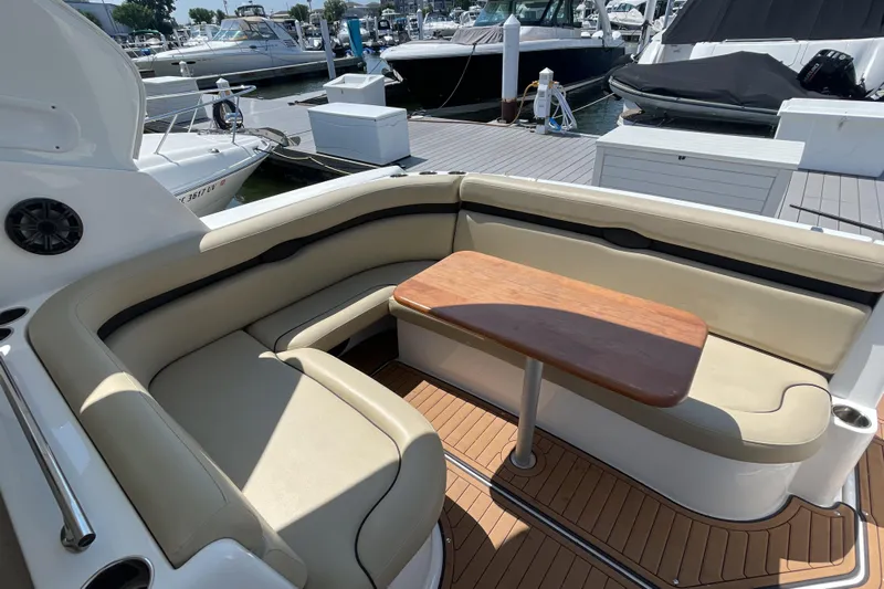  Yacht Photos Pics 2017 Rinker EX 370 boat interior with beige seating and wooden table at marina.