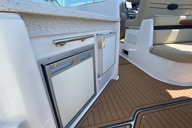  Yacht Photos Pics 2017 Rinker EX 370 boat interior with kitchenette and seating area.