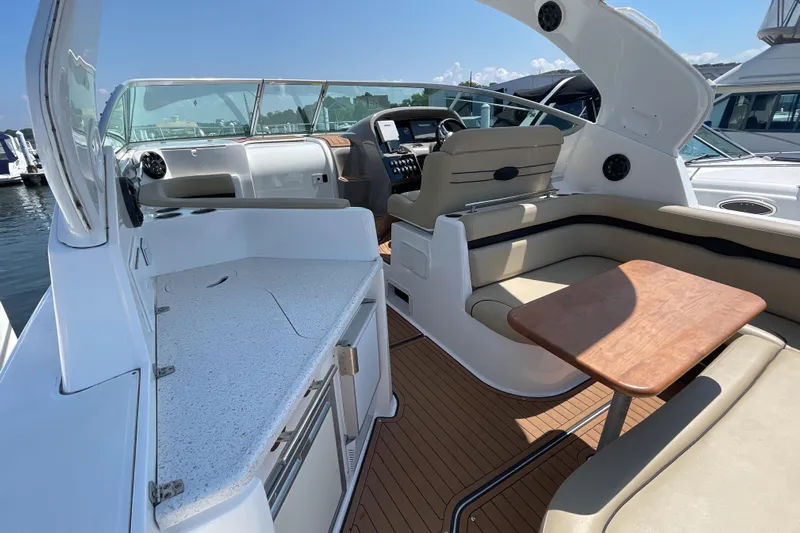  Yacht Photos Pics 2017 Rinker EX 370 boat interior with seating, table, and helm, docked at marina.