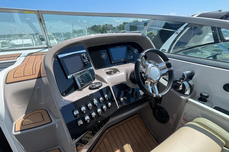  Yacht Photos Pics 2017 Rinker EX 370 boat dashboard with modern controls and steering wheel.