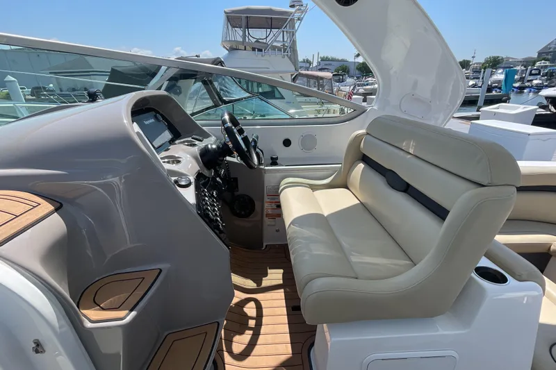  Yacht Photos Pics 2017 Rinker EX 370 boat interior with beige seating and modern dashboard.