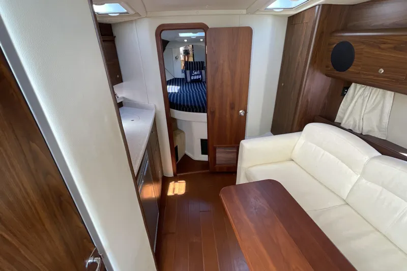  Yacht Photos Pics 2017 Rinker EX 370 yacht interior with wood finishes and white seating.