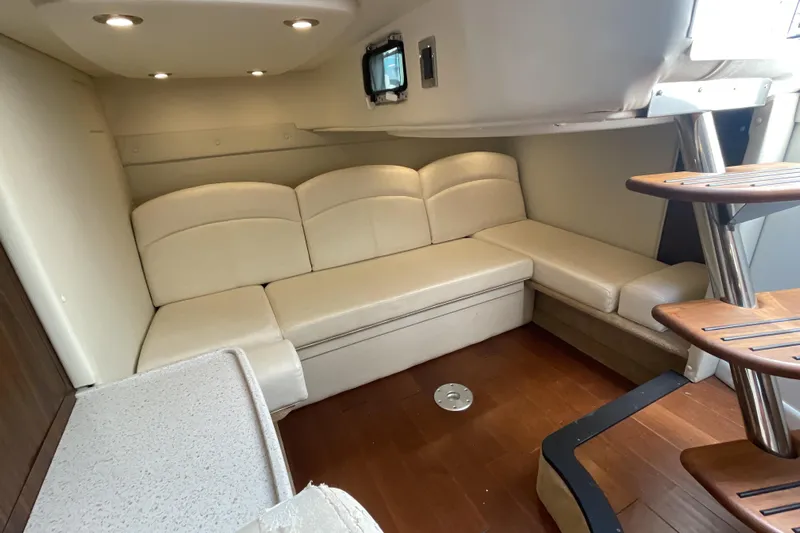  Yacht Photos Pics Interior of a 2017 Rinker EX 370 boat with beige seating and wooden flooring.