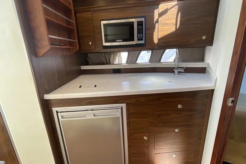  Yacht Photos Pics 2017 Rinker EX 370 yacht kitchen with microwave, sink, and compact fridge.