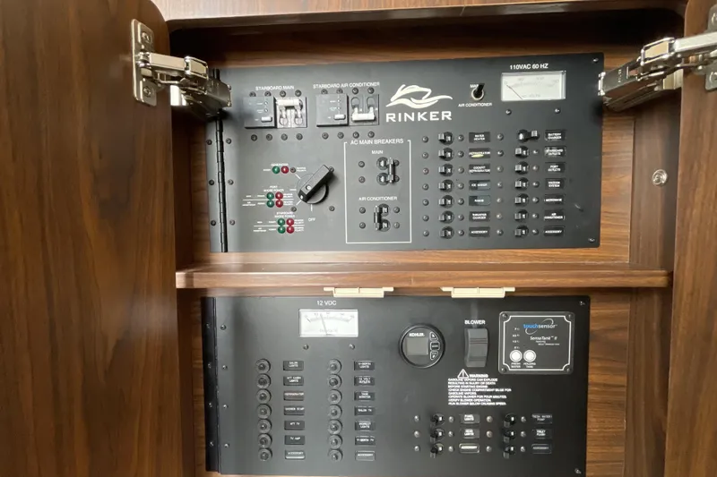  Yacht Photos Pics Electrical control panel of a 2017 Rinker EX 370 boat, featuring switches and indicators.