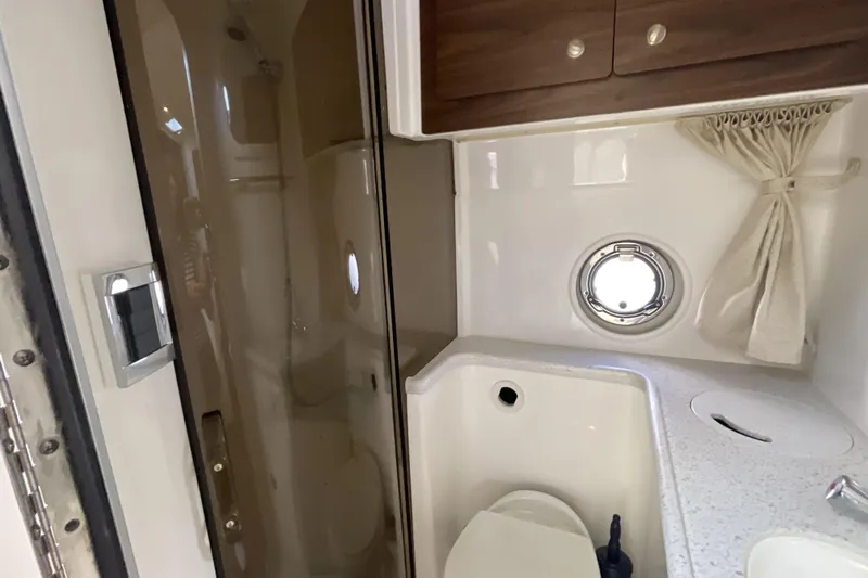  Yacht Photos Pics 2017 Rinker EX 370 bathroom with shower, sink, and porthole window.