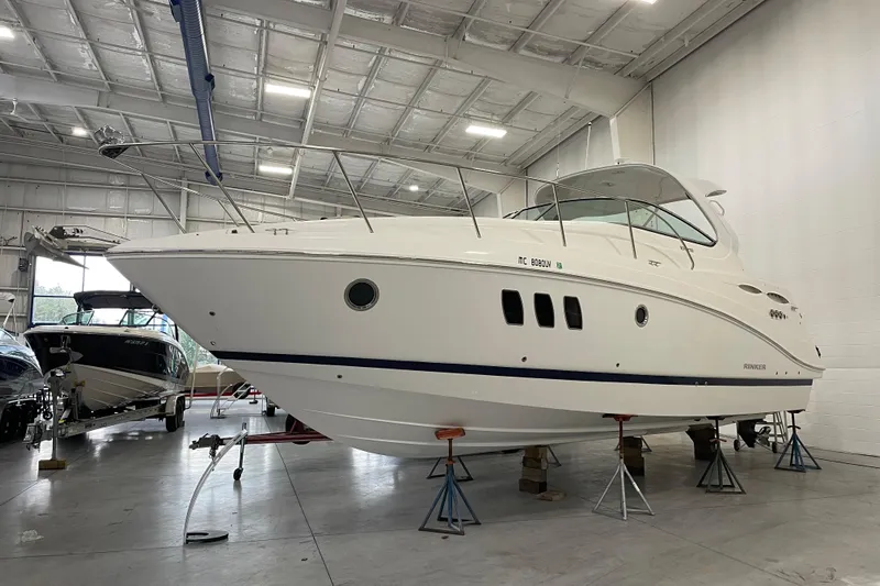  Yacht Photos Pics 2017 Rinker EX 370 boat in a spacious indoor storage facility.